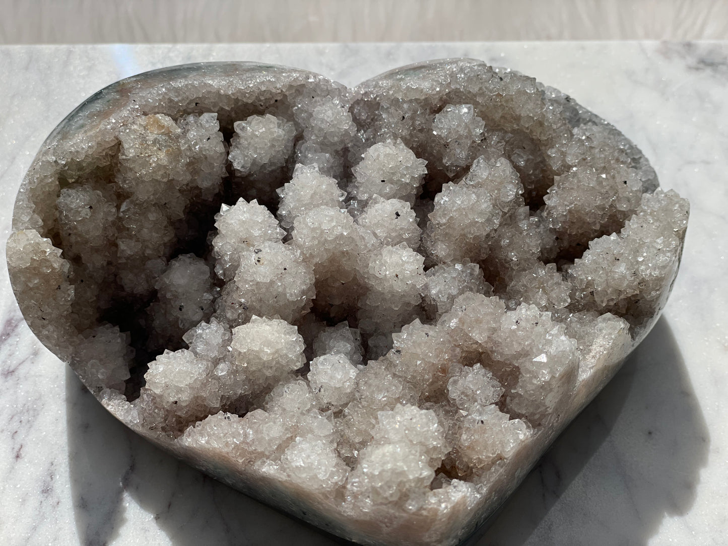 CRYSTAL STALATITE HEART WITH  SMALL BLACK POINTS OF  CALCADONY